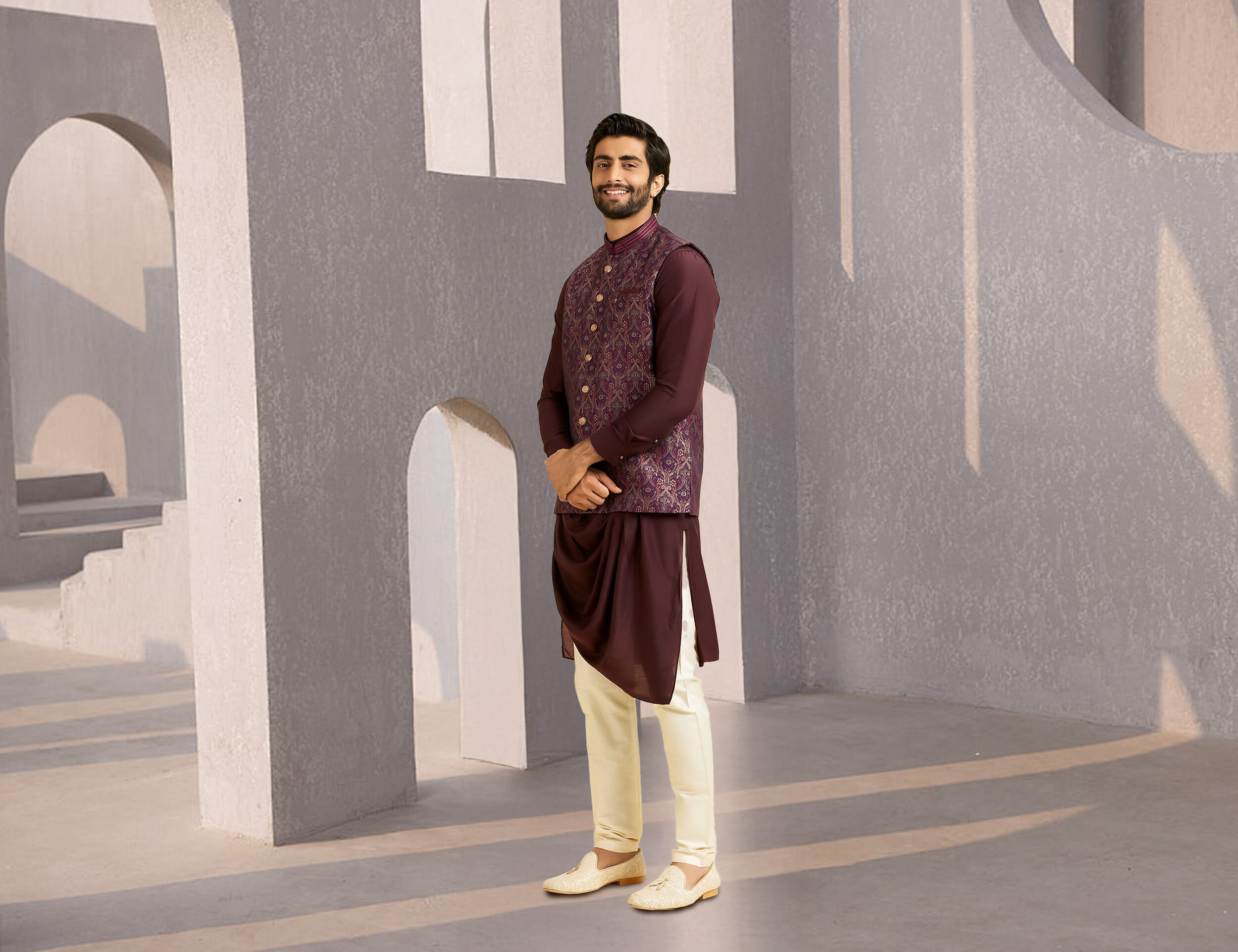 Man in an elegant purple Nehru jacket paired with white juttis, perfect for a sophisticated wedding look.